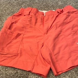 Used mens AFTCO shorts size 34. Coral in color. stains on edge and pockets .
